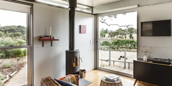 The interior of The House On Soul Hill with a wood fire and valley views